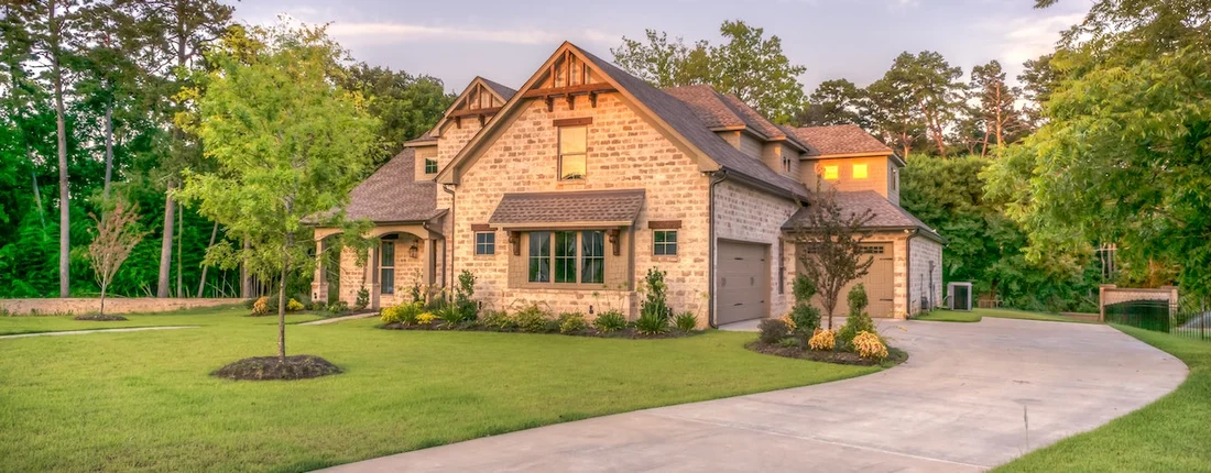 House with a stone facade and landscaped yard